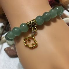 "Embrace the soothing energy of nature with our Green Aventurine Rainy Day Cloud Charm bracelet. Handcrafted with love, this green jewelry piece showcases the mesmerizing beauty of green aventurine beads. Each bead represents the refreshing essence of a rainy day, while the cloud charm adds a touch of whimsy. Wear this beaded bracelet and let its calming vibes uplift your spirit, making rainy days nothing short of magical. Perfect for any nature lover or someone special. PRODUCT DETAILS - Natural green aventurine cloud charm bracelet - 8mm aventurine natural gemstone beads - Antique gold cloud charm - Antique gold bail tube charm holder and spacer - Strong, stretchy cord - Handmade in a clean and safe environment CONTACT US: Do you have any questions, wishes, or want to give us your feedba Holistic Jade Beaded Bracelets As Gift, Round Aventurine Bracelets For Gifts, Aventurine Round Bracelet Gift, Round Aventurine Bracelets As Gifts, Spiritual Aventurine Bracelets As Gift, Aventurine Bracelet As A Gift, Jade Bracelet As May Birthstone Gift, Jade Bracelet For May Birthstone Gift, Jade Bracelet Gift For May Birthstone