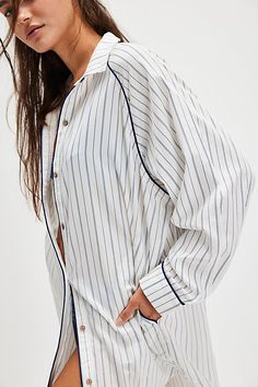 Take it easy in this oversized long-sleeve sleep shirt from We The Free, featured in a PJ-inspired button-down style with a classic pinstripe print and clean piping throughout. **Fit:** Oversized, relaxed **Features:** Cotton-lyocell blend, collared neckline, button-front closure, pinstripe print, piping throughout, rounded hem, logo tag at back **Why We | We The Free Day To Day Sleep Shirt at Free People in White, Size: XS Casual Pinstripe Tops With Button Cuffs, Long Sleeve Sleep Tops For Spring, Long Sleeve Tops For Spring Sleep, Spring Long Sleeve Sleep Tops, Relaxed Fit Button-up Sleepwear, Casual White Button-up Sleepwear, Oversized Pinstripe Long Sleeve Shirt, Classic White Long Sleeve Sleepwear, Striped Button-up Tops For Loungewear