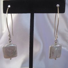 These edgy freshwater pearl earrings are very modern and geometric.  For a contemporary look, our sterling silver earrings are truly unique.   The earrings are handmade and just under 2 and a half inches in length. They have a drop of 1 inch and are 5/8 of an inch wide (.625 inches). Ultra contemporary and fun! Modern Everyday Pearl Earrings, Modern Single Pearl Earring For Everyday, Modern Pearl Jewelry With Matching Earrings, Modern Hypoallergenic Pearl Earrings For Everyday, Modern Pearl Earrings With Ear Wire For Everyday, Modern Drop Pearl Earrings, Modern Everyday Pearl Drop Earrings, Modern Silver Linear Earrings With Pearl Drop, Minimalist Nickel-free Dangle Pearl Earrings