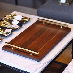 a table topped with wooden cutting boards on top of a white marble covered countertop