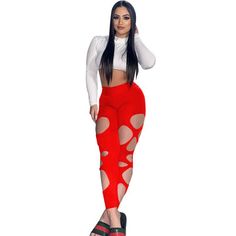 a woman wearing red leggings with holes on the side and black heels, standing in