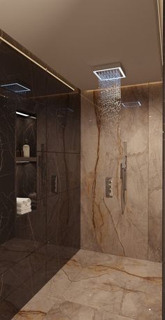 a bathroom with marble walls and flooring, shower head in the corner next to toilet paper