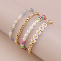 A stretch bracelet set featuring alphabet-letter beads, shimmering pearls and rainbow disc accents. Includes white and 18k gold-plated text beaded stretch bracelet, 18k gold-plated beaded stretch bracelet, blue and white beaded stretch bracelet and pearl and pink multicolor beaded stretch bracelet (four pieces total) Full graphic text (white and 18k gold-plated bracelet): Mama. 0.24" H to 0.31" H 6.5" L Each 18k gold-plated copper / acrylic / resin / polymer clay / pearl Trendy Round Jewelry With Letter Beads, Spring Jewelry With Colorful Beads In Gold, Spring Gold Jewelry With Colorful Beads, Adjustable Letter Beads Jewelry For Spring, Colorful Beaded Round Jewelry For Birthday, Trendy Beaded Jewelry For Birthday, Trendy Beaded Jewelry For Birthdays, Trendy Round Bead Jewelry For Mother's Day, Multicolor Beaded Jewelry For Mother's Day