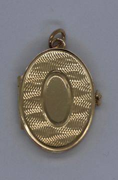 This hand-made oval locket is as sentimental as it gets. It is a beautiful holiday present. It is both beautiful and functional. Most lockets can hold 2 pictures but this one can hold 4 special photos close to your, or your loved one's, heart! It also has room to be personalized with an initial monogram. It is hard to match the workmanship of this locket. It was crafted by a very talented jeweler in the NYC jewelry district between 1970 - 1980. Lockets are his legacy and his remaining inventory Oval Cameo Keepsake Jewelry, Luxury Oval Locket Necklace As Gift, Timeless Oval Locket Necklace For Gift, Luxury Yellow Gold Oval Locket Necklace, Timeless Oval Locket Necklace, Timeless Gold Oval Locket Necklace, Timeless Engraved Oval Locket Necklace, Heirloom Oval Locket Necklace Keepsake, Timeless Oval Engraved Locket Necklace