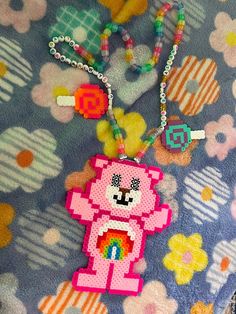 a close up of a stuffed animal on a blanket with beads and necklaces hanging from it