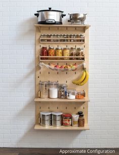 a wooden shelf filled with lots of food and condiments next to a white brick wall