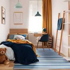 there is a teddy bear sitting on the floor in this small child's room