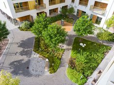 an aerial view of a courtyard with trees and bushes