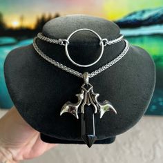 Handmade . Double Layer Necklace . Vampire Bat Wings And Black Onyx Bullet Charm . Wheat Chain Style Are Stainless Steel Material ( Nickel Free , Allergy Free , Hypoallergenic , No Itching , Do Not Change Color ) First Layer With O Ring Is 14 Inch Long And Second Is 16 Inch Long ( Necklace Is Adjustable And Has A 3 Inch Extention On The Back As Well To Wear Longuer If Needed ) Tags : Gem / Gems / Gemstones / Crystals / Boho / #Bohemian / Bohochic / Goth / #Gothic / Punk / Emo / Victorian / Queen / Viking / Celt / #Celtic / #Vampire / Bats / Wings / Dracula / Moon Child / Witch / Fairy / Mermaid / Unicorn / Rock & Roll / Rocker / Rock Chic / Biker / Gift / Stylish / Trendy / Festival / Design Silver Vampire Style Necklace, Silver Punk Necklace For Cosplay, Punk Silver Necklace For Cosplay, Silver Punk Jewelry For Cosplay, Silver Alternative Jewelry For Cosplay, Silver Edgy Jewelry For Cosplay, Edgy Silver Jewelry For Cosplay, Alternative Metal Jewelry For Cosplay, Silver Gothic Jewelry For Cosplay