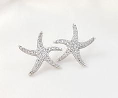 "These cubic zirconia starfish stud earrings are made with your choice of gold, rose gold or silver finish. These sparkly 1-inch star fish earrings are perfect for beach weddings and make a great bridesmaid ask or bridal party gift. The posts on these nautical earrings are at the top of the back of the stud earring. Thank you for looking.   For the matching necklace: https://www.etsy.com/listing/581787868/new-starfish-necklace-rose-gold-beach?click_key=ac9e4a110acd106ffe2b02f3e39a483877ea19e4%3A Beach Themed Wedding, Rhodium Jewelry, Nautical Earrings, Jewelry Rose Gold, Fish Earrings, Gold Beach, Asking Bridesmaids, Etsy Boutique, Earrings Beach