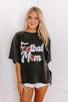 - Sparkle on the sidelines with this adorable 'FOOTBALL MOM' top! Perfect for showing your team spirit, this piece is comfy-casual style with a touch of glam. Its eye-catching design makes it a must-have for every proud football mom. - Unlined sweatshirt material with a vintage wash - A white and red hued 'FOOTBALL MOM' graphic design with rhinestone accents - Unfinished seam accents - A crew cut neckline - Short, loose sleeves - An ultra-relaxed silhouette that ends in a high-low hemline with s Football Mom Shirts, Mom Era, Crew Cut, Loose Sleeves, Crew Cuts, Embellished Top, Football Mom, Distressed Shorts, White And Red