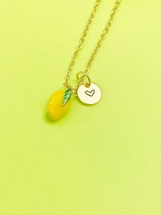 This is gold tone yellow mangoes charm with hand stamped initial charm on brass/stainless steel 18 inches chain. ♥ You will receive 1 necklace. HOW TO ORDER 1) Select the quantity 2) Select the initial  3) Add to cart DESCRIPTION ♥ Necklace, Gold Plated over Brass or Stainless-steel Cable Chain with Lobster Claw Clasp, Size: about 17.7 inches (45cm) long, 1-2mm wide, Nickel Safe, ♥ Initial Charms, Gold Plated over Stainless steel, Size: about 8-10mm in diameter, 1mm thick, Nickel Safe, ♥ Mangoes Charm, Brass Enamel Charms, Imitation Fruit, Light Gold, Mangoes Charm, Gold, Size: about 0.30 inch(7.5mm) wide, 0.47 inch(12mm) long, 0.31 inch(8mm) thick, ♥ We are happy to help with any situation so please reach out with any concerns. ♥ Materials from the USA and international sourcing. ♥ I do n Yellow Dangle Necklaces As Gifts, Handmade Gold Charm Necklaces For Best Friend, Handmade Gold Charm Necklace For Best Friend, Nickel Free Pendant Charm Necklace For Best Friend, Nickel-free Pendant Charm Necklaces For Best Friend Gift, Nickel-free Pendant Charm Necklace For Best Friend, Yellow Charm Necklace With Lobster Clasp For Gift, Gold Hallmarked Jewelry For Best Friend Gift, Adjustable Cadmium-free Charm Necklace For Gift