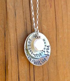 These 1" & 3/4" solid sterling silver discs are gently textured, hand stamped with your custom personalization and then gently cupped to cradle the beautiful freshwater coin pearl & Bali silver drop.  Put the names of your children, meaningful dates, descriptive words, etc. . . .whatever your heart desires!***Character limit on this necklace (spaces count as a character):Large disc - 18Small disc - 22Each necklace comes hung on a beautiful 18" sterling silver chain. I also include a smal Meaningful Sterling Silver Jewelry For Birthday, Sterling Silver Jewelry For Birthday, Mother's Day 925 Silver Round Pendant, Spiritual Hand Stamped Jewelry With Round Pendant, Stamped 925 Round Pendant For Mother's Day, Spiritual Hand Stamped Round Pendant Jewelry, Spiritual Hand-stamped Round Pendant Jewelry, Mother's Day 925 Stamped Round Pendant Jewelry, Meaningful Engraved Jewelry For Birthday