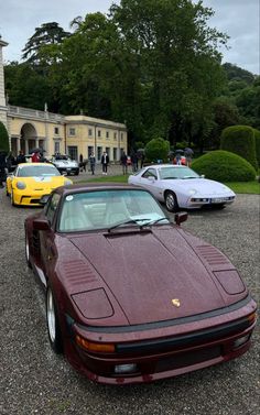 several cars parked in front of a large building