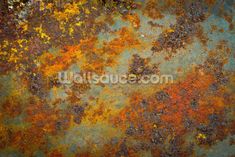 an old rusted metal surface with orange and yellow paint