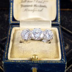 three stone diamond ring in an open box