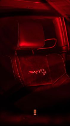 the interior of a car with red lighting