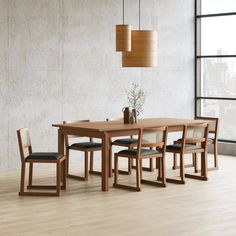 a dining room table and chairs in front of a large window with a vase on it