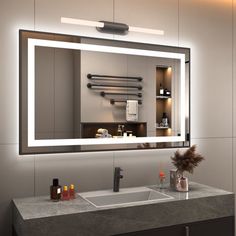 a bathroom with a sink, mirror and lights