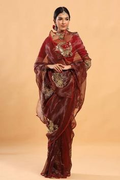 a woman in a red and gold sari