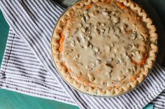 a pie sitting on top of a table covered in gravy