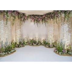 an image of a wedding ceremony setting with flowers and greenery on the stage backdrop