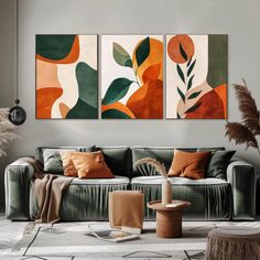 a living room with three paintings on the wall and one is green, orange and white