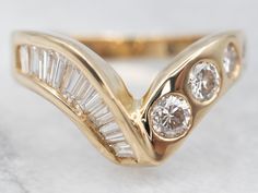 a gold ring with three diamonds on it