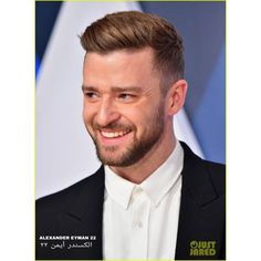 a close up of a person wearing a suit and smiling