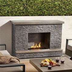 an outdoor fireplace in the middle of a patio