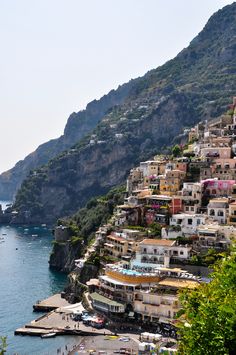 an aerial view of a town on the edge of a body of water