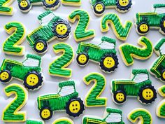 decorated cookies in the shape of tractors and numbers for two - year old children's birthdays