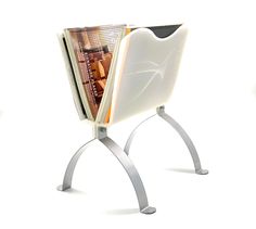 a magazine holder with two magazines on it's legs and a white back ground