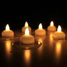 several lit candles sitting on top of a table