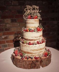 a wedding cake with strawberries and berries on top