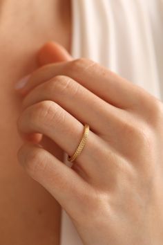 a woman's hand with a gold ring on it