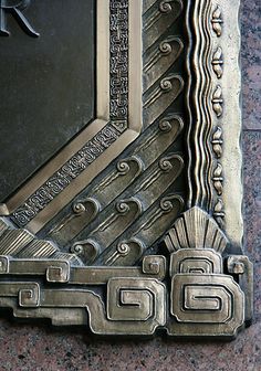 a decorative metal plaque on the side of a building