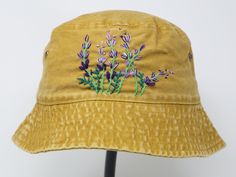 Item: flower embroidered bucket hat Material: 100% cotton Size: one size fits most Embroidery: hand made with acrylic thread Free first class shipping, upgradable priority mail service. 30 days return policy, feel confident at your purchase! Yellow Cotton Bucket Hat With Short Brim, Yellow Cotton Bucket Hat For Spring, Spring Yellow Cotton Bucket Hat, Yellow Cotton Bucket Hat With Curved Brim, Yellow Adjustable Cotton Bucket Hat, Spring Wide Brim Bucket Hat With Embroidered Logo, Handmade Yellow Cotton Hats, Summer Cotton Bucket Hat With Embroidered Logo, Spring Bucket Hat With Embroidered Logo