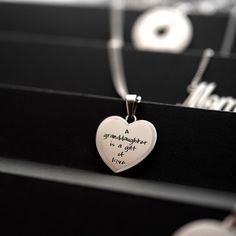 Celebrate the precious bond between a granddaughter and her grandparents with this beautiful heart pendant necklace from Joyful Sentiments. Exquisitely crafted in Stainless Steel, the pendant features the heartfelt engraving "A Granddaughter is a Gift of Love" accented with a shimmering cubic zirconia stone set in the center of the letter "O". The pendant hangs gracefully from an 18 inch Stainless Steel chain with a 3 inch extender, allowing you to adjust the length for the perfect fit. Stainles Anniversary Stainless Steel Heart Pendant Necklace, Stainless Steel Heart Pendant Necklace For Anniversary, Mother's Day Heart Pendant Necklace In Stainless Steel, Personalized Stainless Steel Heart Necklace For Mother's Day, Mother's Day Stainless Steel Heart Pendant Necklace, Stainless Steel Heart Pendant Necklace For Mother's Day, Mother's Day Stainless Steel Necklace For Mom, Mother's Day Gift Stainless Steel Necklace, Personalized Gift Necklace With Heart Charm