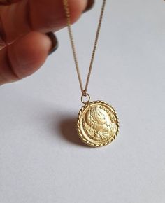 Solid gold coin necklace, 14k gold necklace, coin pendant necklace, medallion necklace, coin necklace, gold pendant necklace An old Greek coin, made of solid gold which was duplicated and wrapped with twisted gold wires to make a beautiful medallion pendant. The antique coin is not a perfect circle in shape and a little rustic. The necklace is available in gold filled, sterling silver, 9k and 14k solid gold. You can also purchase the pendant only if you wish. This 14k gold coin necklace is great Gold Plated Yellow Gold Medallion Necklace, Brass Coin Medallion Necklace, Brass Medallion Coin Necklace, Brass Coin Pendant Necklace In Medallion Shape, Brass Medallion Necklace With Coin Pendant, Tarnish-resistant Yellow Gold Coin Necklace, Yellow Gold Plated Coin Necklace, 14k Gold Necklace With Coin Pendant, 14k Gold Necklace With Round Coin Pendant