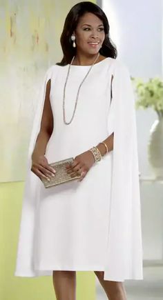 a woman in a white dress holding a gold purse