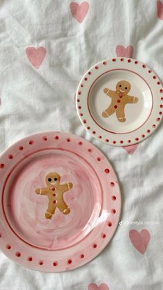 two pink and white plates with hearts on them, one has a ginger man in the middle