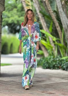 ERTE KAFTAN TROPICAL Elevate your wardrobe with our sophisticatedly designed Erte Kaftan featuring a tropical pattern. This versatile garment can be effortlessly style over your bikini, dress, shorts, or pants, and elegantly fastened in the front for a chic and upscale look. Open front ¾ sleeves Thigh high slits on sides 60" length 100% Chiffon Hand Wash or Delicate Cycle and Hang Dry The print is an original Ramona La Rue hand painted by the designer and transferred to fabric. Every garment has Tropical V-neck Swimwear With Tropical Print, V-neck Tropical Print Swimwear For Vacation, Summer V-neck Cover-up With Tropical Print, Hawaiian Summer Swimwear, Hawaiian Style Swimwear For Summer Outings, Green Swimwear For Summer Outings And Beach Season, Hawaiian Swimwear For Beach Season, Summer Floral Print Swimwear For Beach, Summer Floral Print Beach Cover-up Swimwear