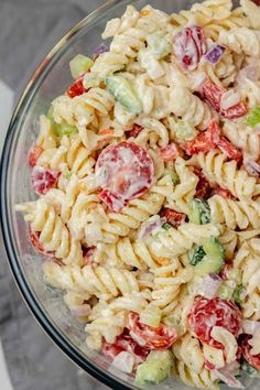 a bowl filled with pasta salad on top of a table