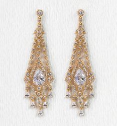 two pairs of gold tone earrings with clear crystal stones on each side and dangling from the sides