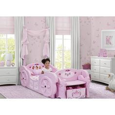 From pretty princesses to royal castles, the toddler bed from Delta Children evokes the characters and stories girls love to dream about. Ready to transform any room into an enchanted space for adventures real and imagined, the bed is designed with all the regal trimmings. It features two intricately detailed posts draped with fabric (for use when converted into a twin bed), crystal gems for a bit of bling on the wheels, plus a throne-like storage bench for the foot of the bed. Like a glass slip Pink Toddler Bed, Disney Princess Carriage, Convertible Toddler Bed, Bedside Bassinet, Walmart Bedding, Princess Carriage, Portable Crib, Royal Castles, Toddler Mattress