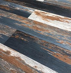 an old wood floor with peeling paint on the top and bottom part of it's surface