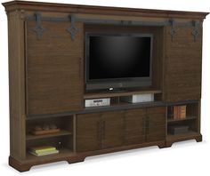 a large entertainment center with a flat screen tv on it's side and shelves