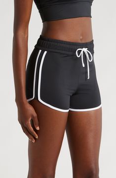 You will move with ease from land to sea in these stretch-enhanced swim shorts topped with a high waist. 3 1/2" inseam   Lined   80% recycled polyester; 20% spandex   Hand wash, line dry   Imported Sporty Swim Trunks With Built-in Shorts, Sporty Black Swimwear With Built-in Shorts, Sporty Swim Skirt For Workout, Black Nylon Shorts For Beach Season, High-waisted Athletic Shorts With Built-in Shorts For Beach, Sporty Moisture-wicking Swim Skirt, Summer Activewear Shorts With Contoured Waistband, Summer Athleisure Activewear With Short Inseam, Summer Workout Shorts Made Of Elastane