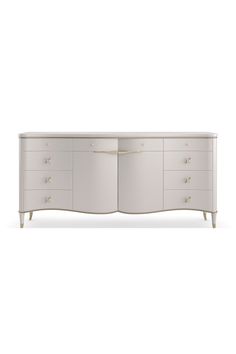 the sideboard is white and has two drawers, one with gold pulls on it